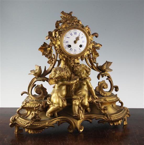 A Louis XV style gilt metal eight day mantel clock by Marshall & Sons, Paris, 17in.